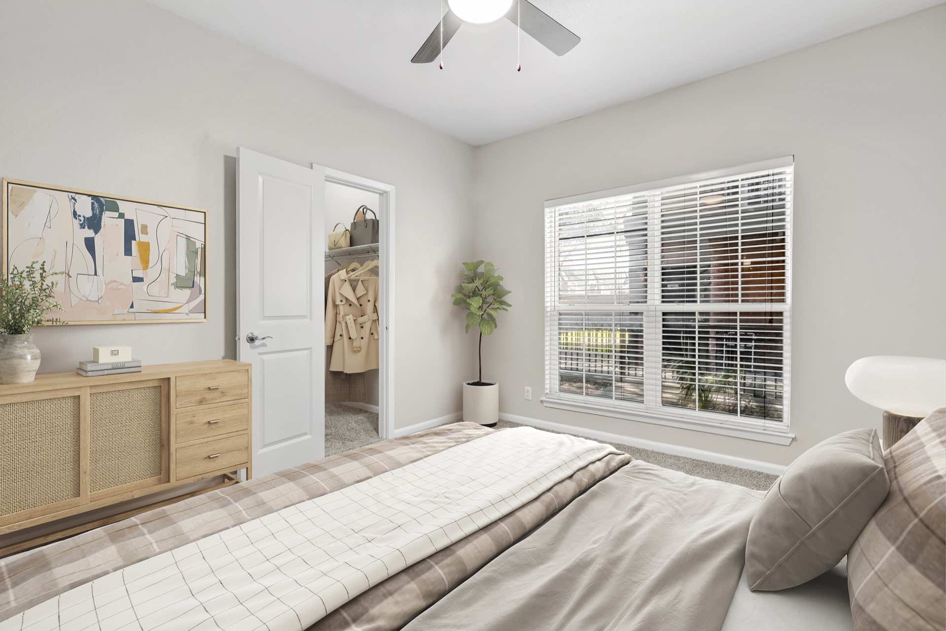 bedroom with large window and ceiling fan