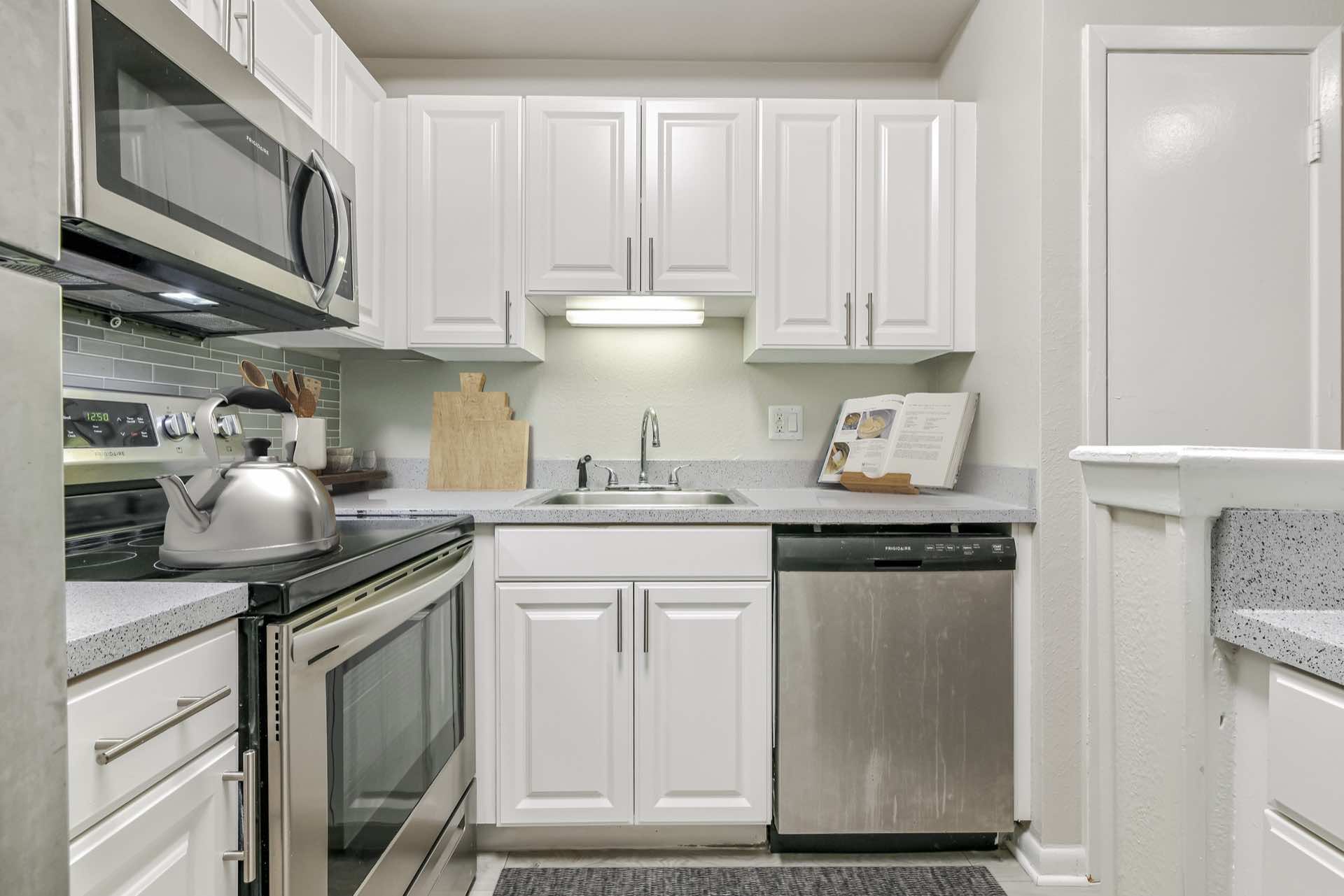stainless steel appliances and white cabinets in kitchen