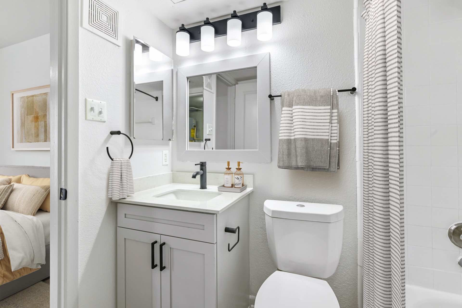 updated bathroom with modern lighting